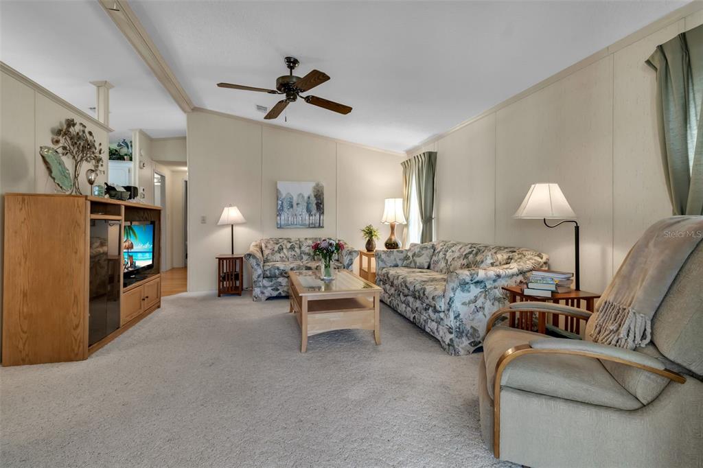 10315 Cortez Road West, Unit 26J Bradenton, FL 34210 - Photo 3 of 69 a living room with furniture and a flat screen tv