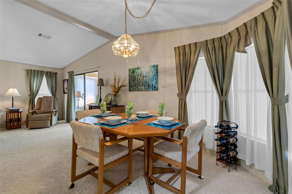 10315 Cortez Road West, Unit 26J Bradenton, FL 34210 - Photo 4 of 69 a view of a dining room with furniture and a chandelier