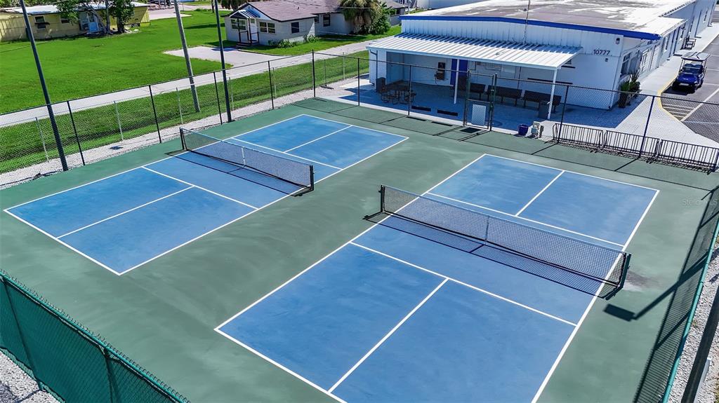 10315 Cortez Road West, Unit 26J Bradenton, FL 34210 - Photo 54 of 69 a view of a tennis ground with large trees in front of it