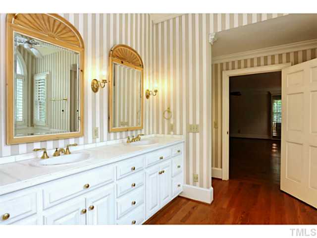 817 Lassiter Place Raleigh, NC 27609 - Photo 12 of 24 a bathroom with a double vanity sink and mirror