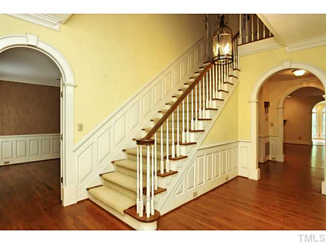 817 Lassiter Place Raleigh, NC 27609 - Photo 3 of 24 a view of entryway and hall with wooden floor