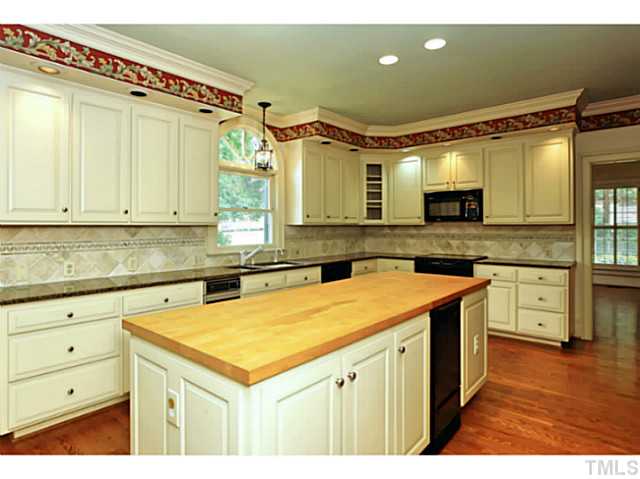 817 Lassiter Place Raleigh, NC 27609 - Photo 9 of 24 a kitchen with a sink a stove and cabinets
