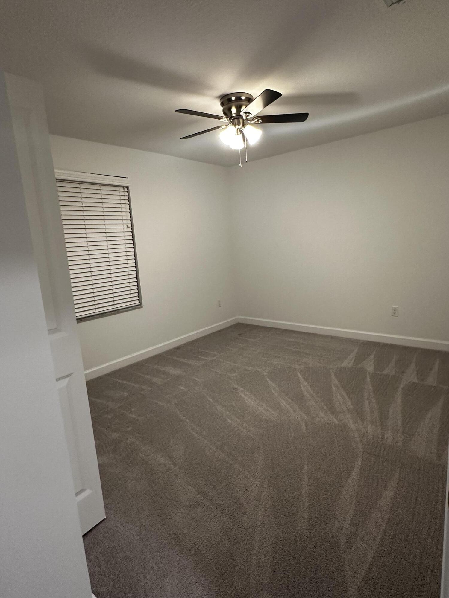 3507 Bauer Road Royal Palm Beach, FL 33411 - Photo 20 of 26 an empty room with windows and fan