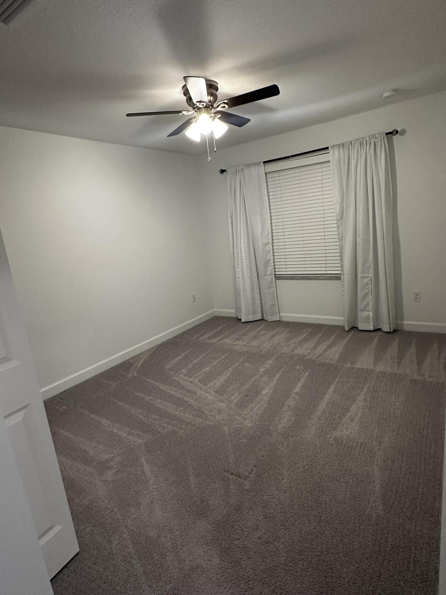 3507 Bauer Road Royal Palm Beach, FL 33411 - Photo 22 of 26 a view of an empty room with a chandelier fan