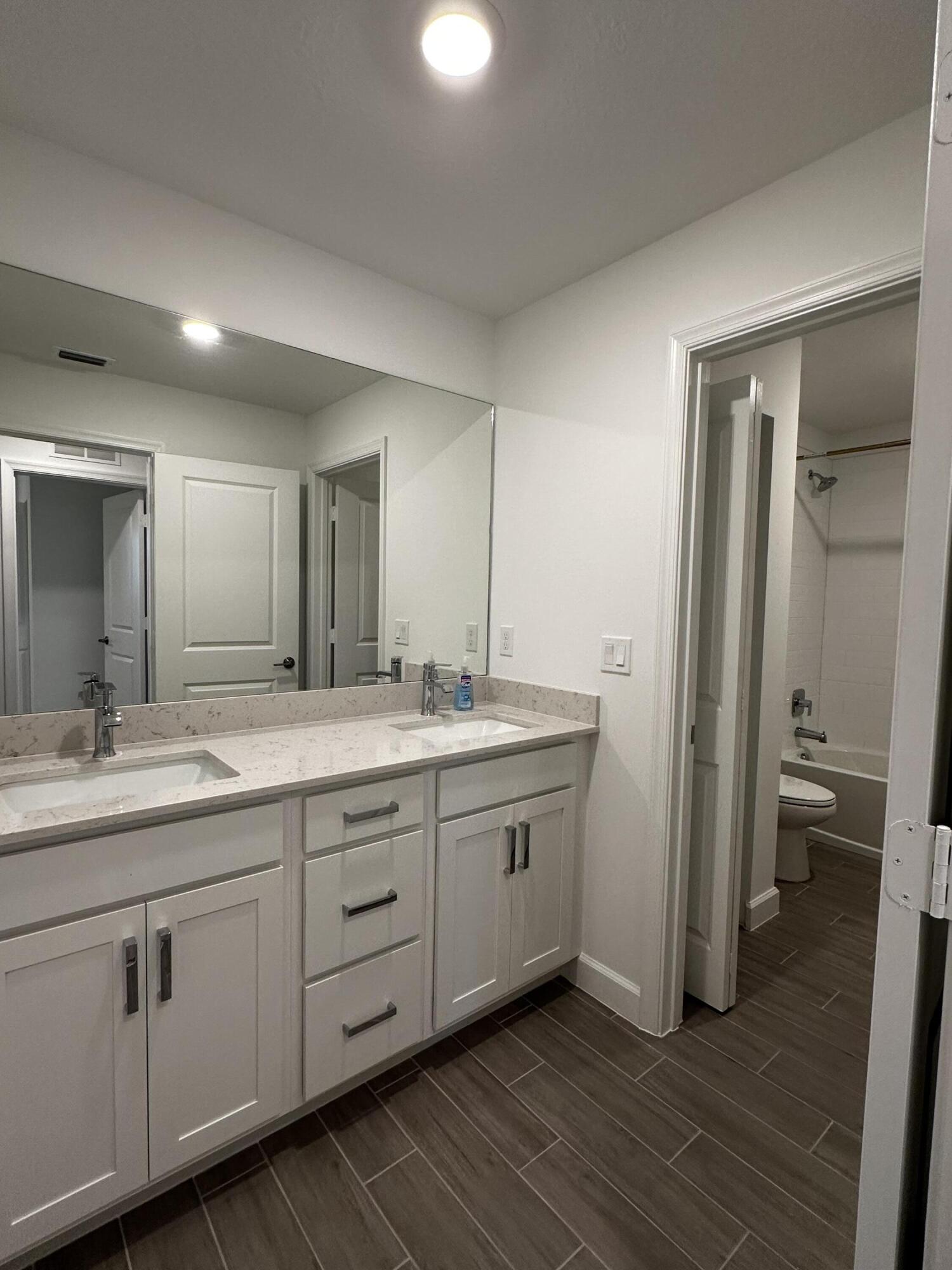 3507 Bauer Road Royal Palm Beach, FL 33411 - Photo 25 of 26 a bathroom with a double vanity sink and a mirror