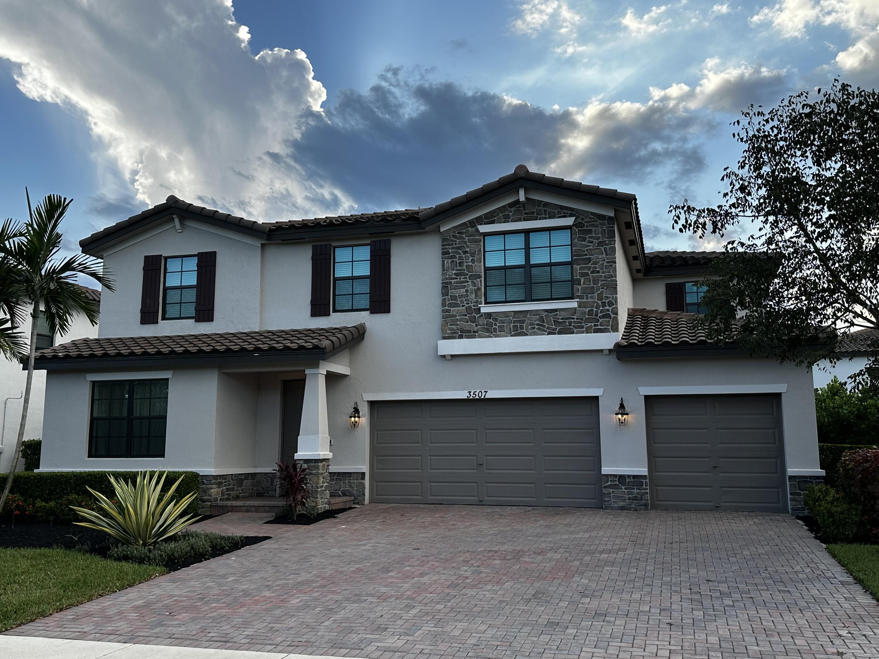 3507 Bauer Road Royal Palm Beach, FL 33411 - Photo 4 of 26 a front view of a house with a yard and garage