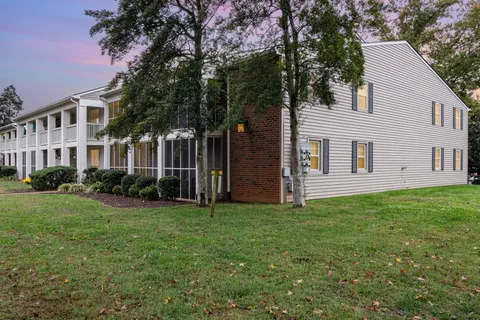 a view of a house with backyard and garden