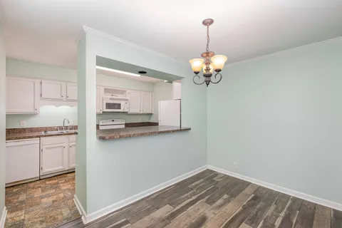 a view of a kitchen with wooden floor and a kitchen
