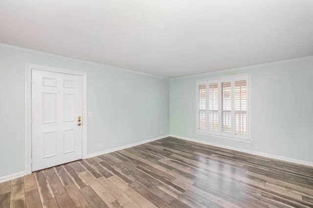 a view of a room with wooden floor and bench