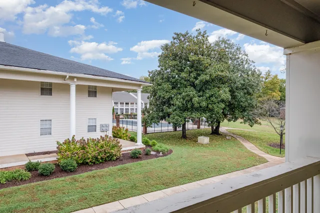 a view of a house with backyard sitting area and garden