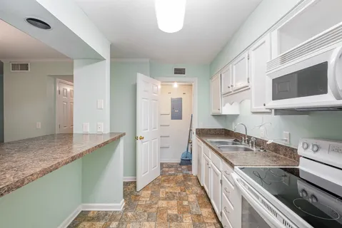 a kitchen with a sink and a refrigerator
