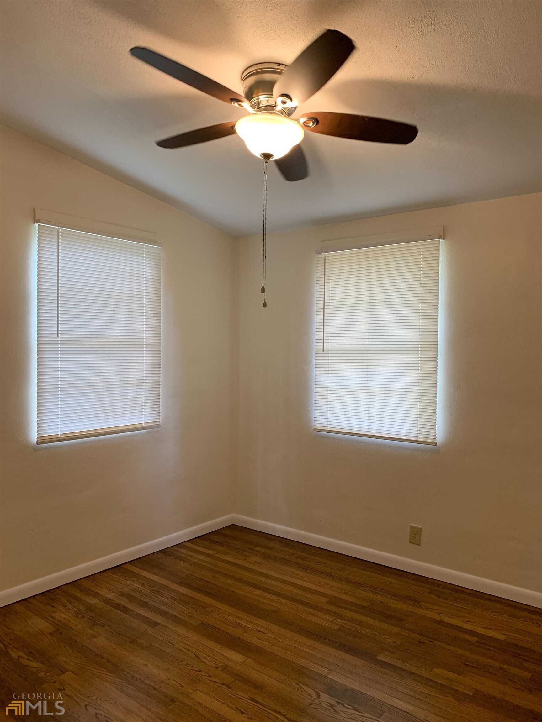174 Hart Avenue Athens, GA 30606 - Photo 11 of 13 a view of an empty room with wooden floor and a window