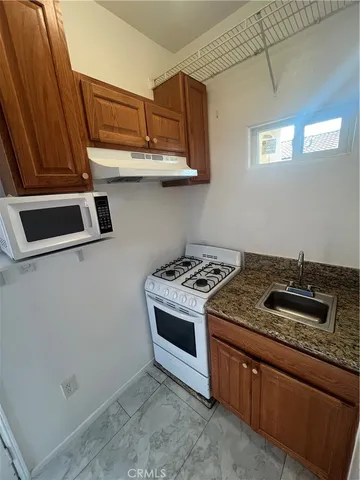 a kitchen with stainless steel appliances granite countertop a stove and a sink