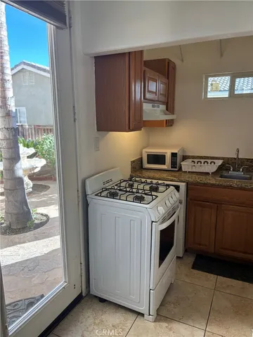 a white stove top oven sitting inside of a kitchen