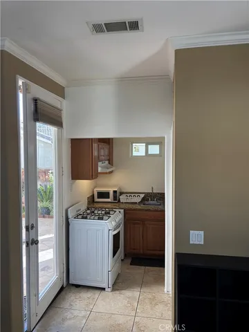 a kitchen with stainless steel appliances granite countertop a stove and a refrigerator