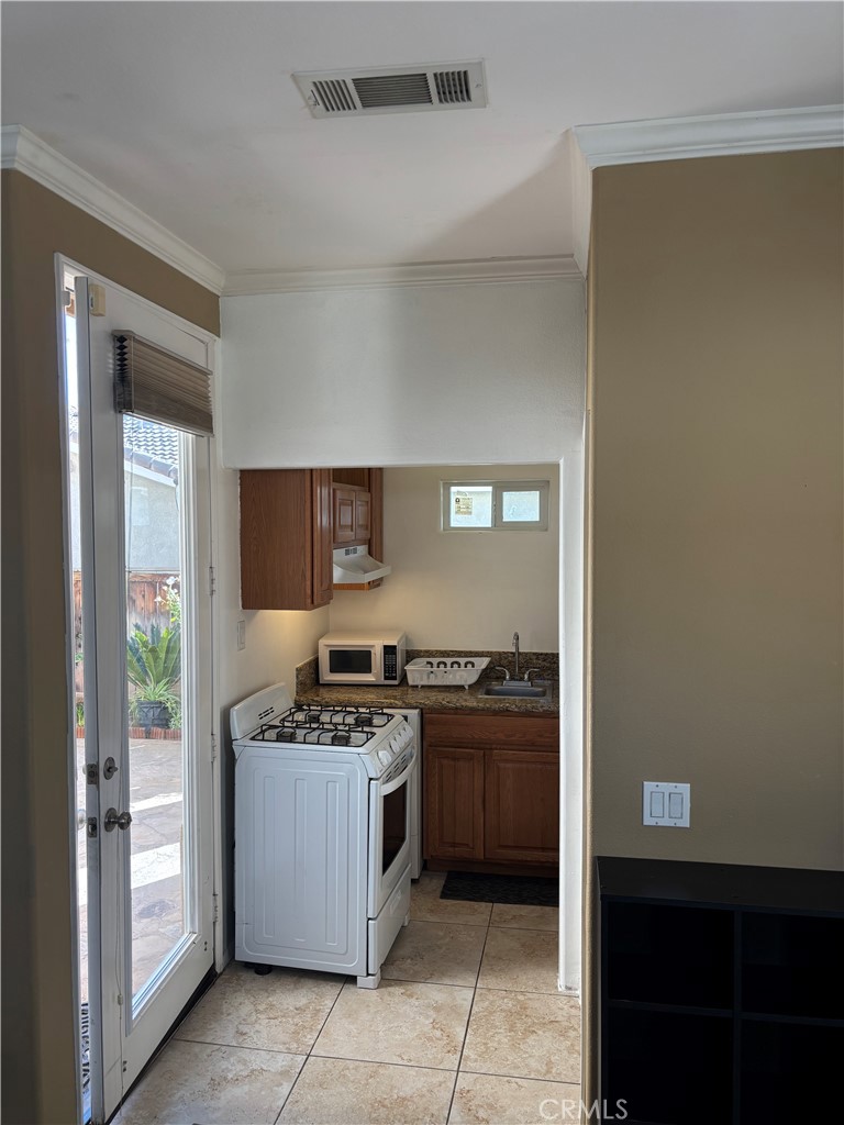 9840 Shadow Mountain Drive Moreno Valley, CA 92557 - Photo 4 of 8 a kitchen with stainless steel appliances granite countertop a stove and a refrigerator