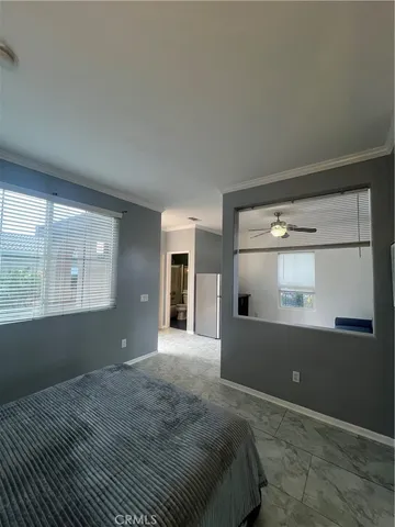 a bedroom with a bed and window