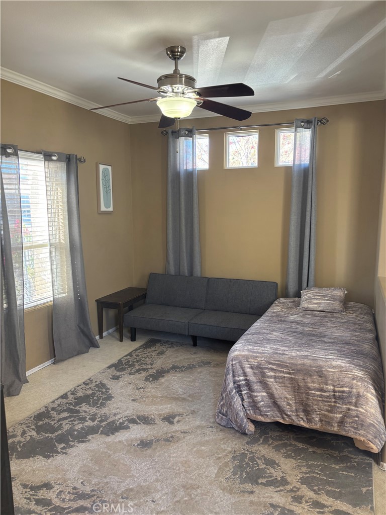 9840 Shadow Mountain Drive Moreno Valley, CA 92557 - Photo 6 of 8 a bedroom with a bed and a window