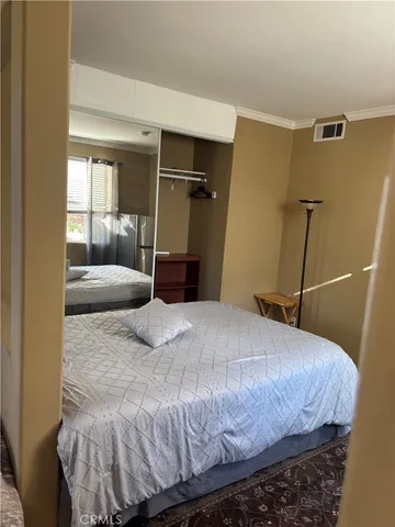 a bedroom with a bed and walk in closet