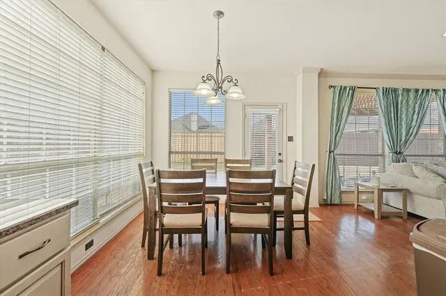 a kitchen with a table chairs and flat screen tv