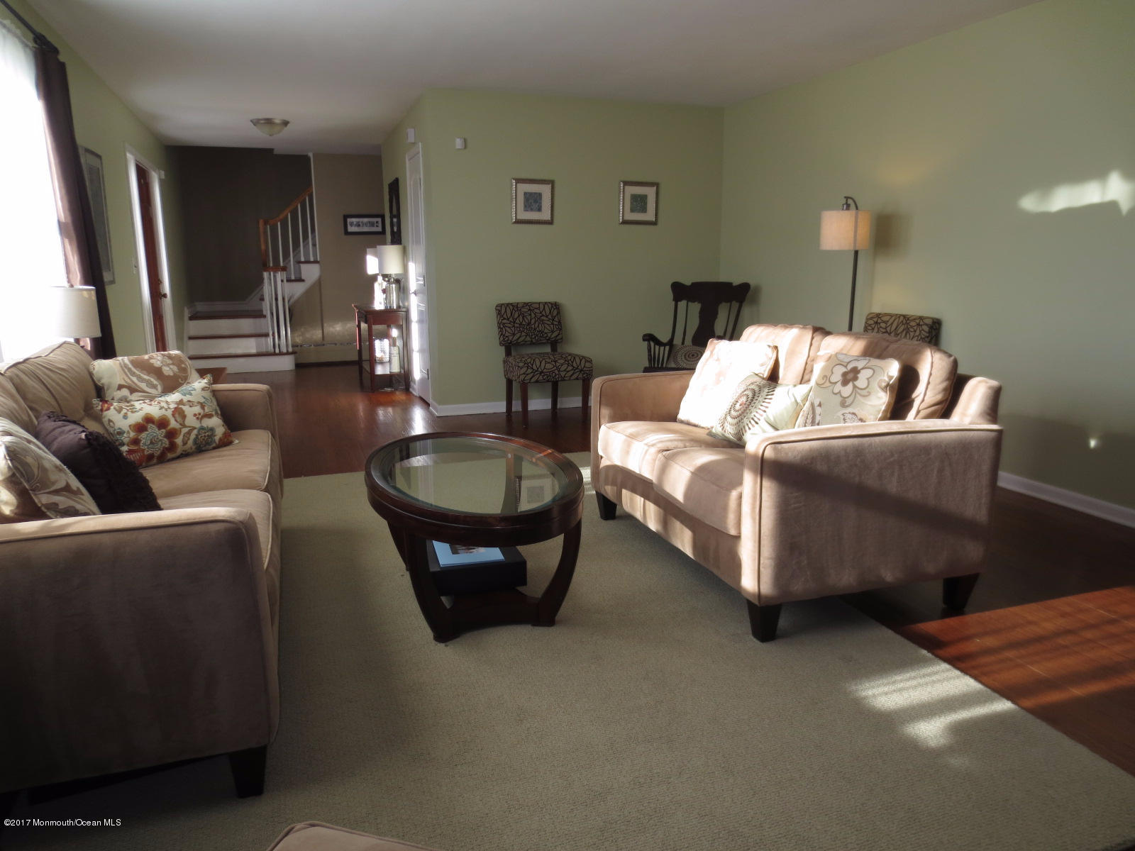 131 Ravine Drive Matawan, NJ 07747 - Photo 3 of 23 a living room with furniture a lamp and a potted plant