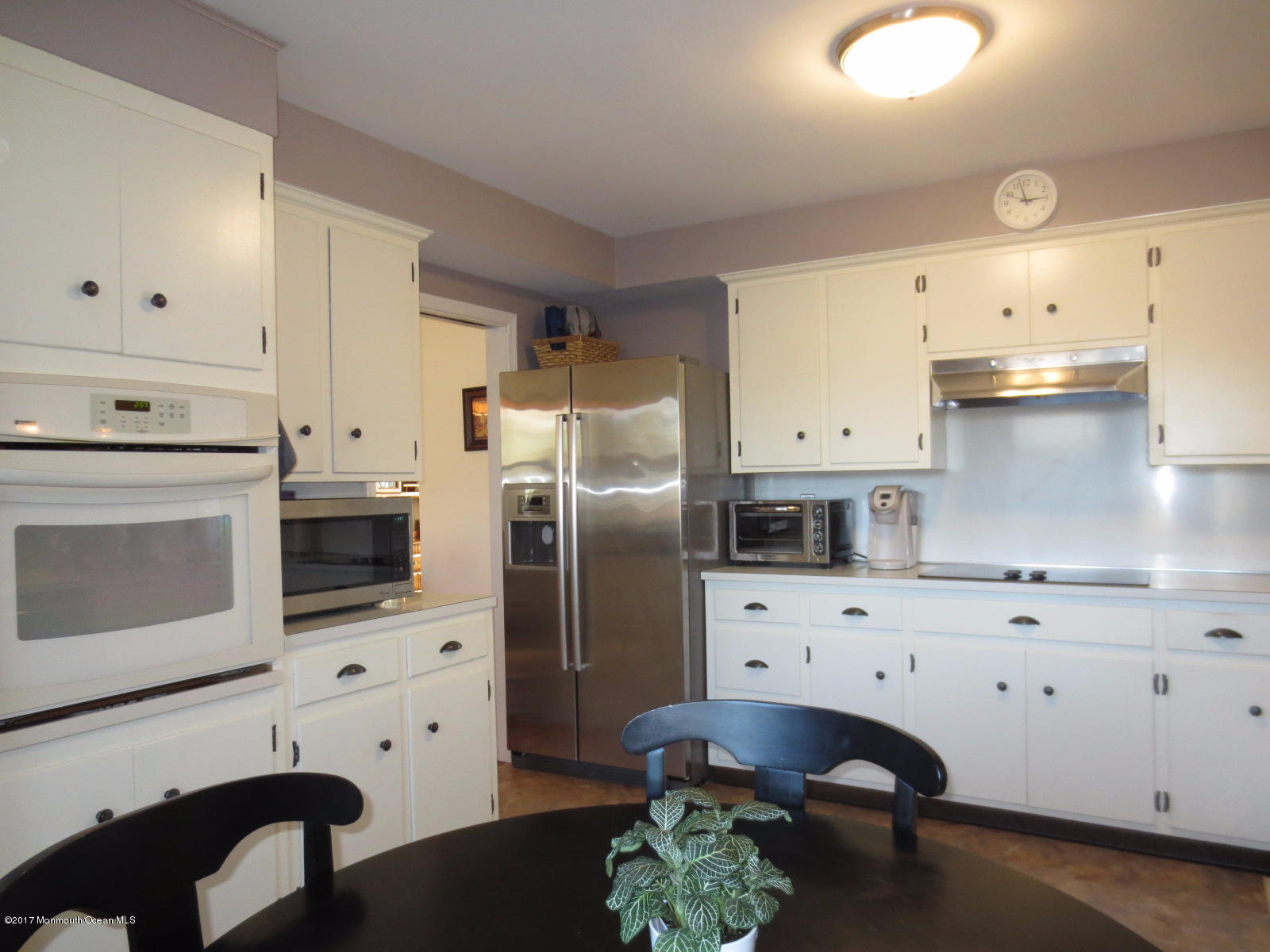 131 Ravine Drive Matawan, NJ 07747 - Photo 5 of 23 a kitchen with stainless steel appliances a stove refrigerator sink and cabinets