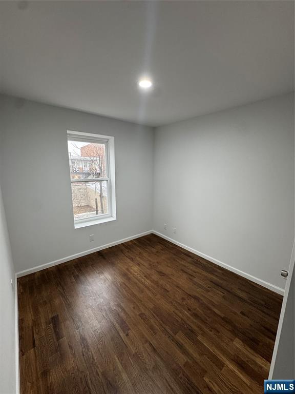 196 Malvern Street, Unit 2 Newark, NJ 07105 - Photo 12 of 16 an empty room with wooden floor and windows