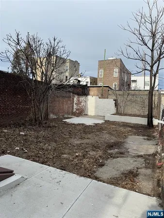 a view of a yard with large trees