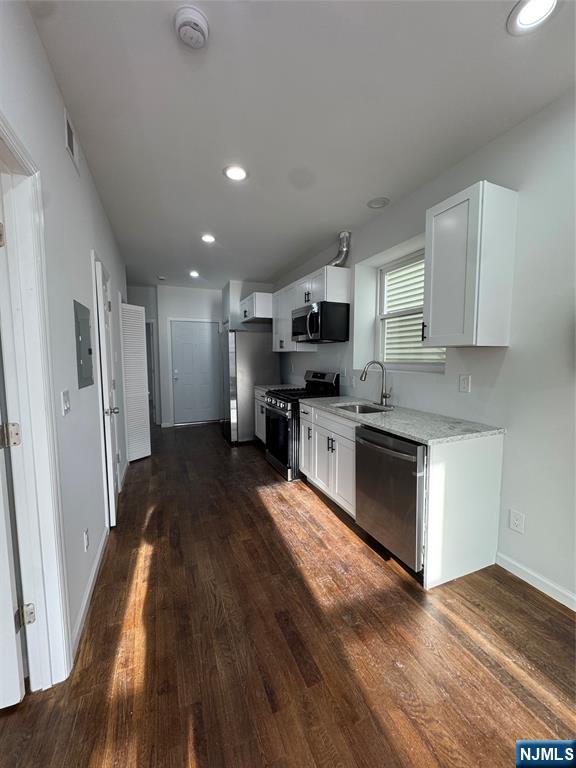 196 Malvern Street, Unit 2 Newark, NJ 07105 - Photo 2 of 16 a large kitchen with cabinets wooden floor and stainless steel appliances