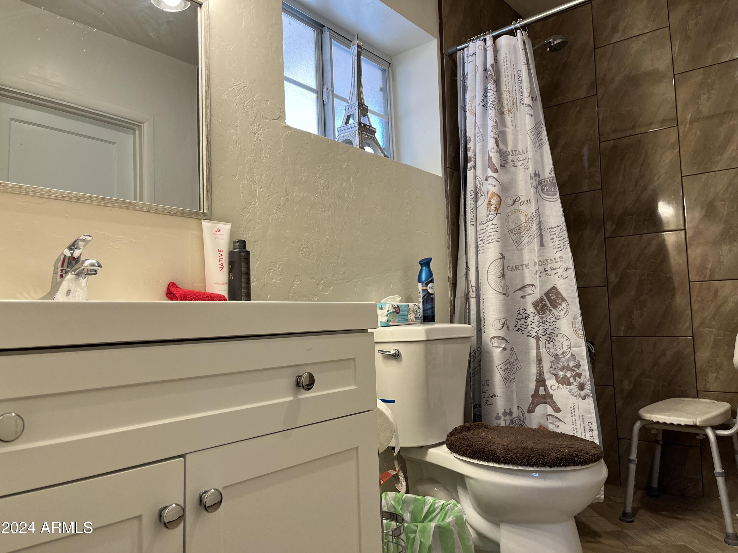 1517 East 9th Street Douglas, AZ 85607 - Photo 12 of 16 a bathroom with a toilet and a shower curtain