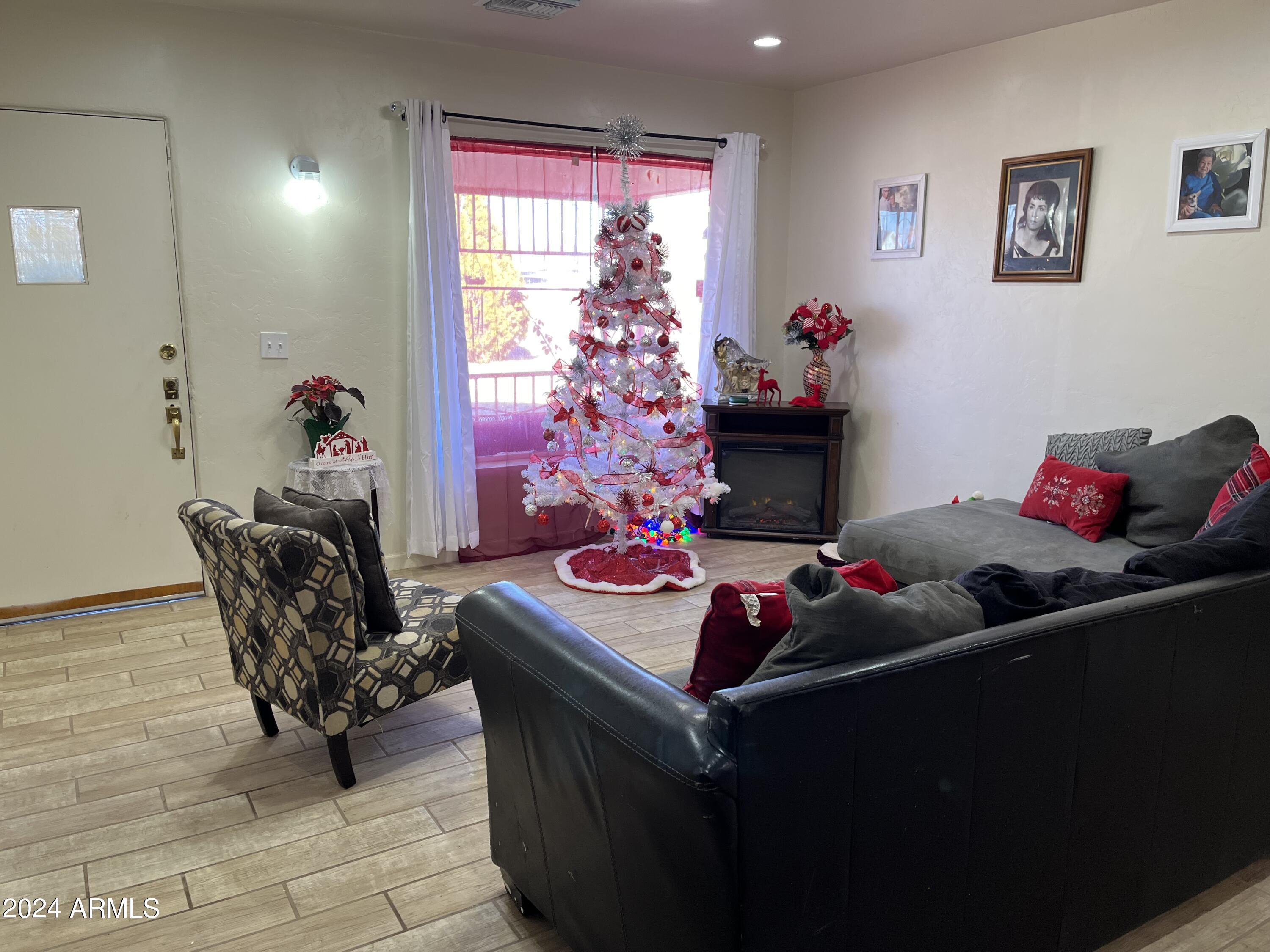 1517 East 9th Street Douglas, AZ 85607 - Photo 3 of 16 a living room with furniture and a flat screen tv