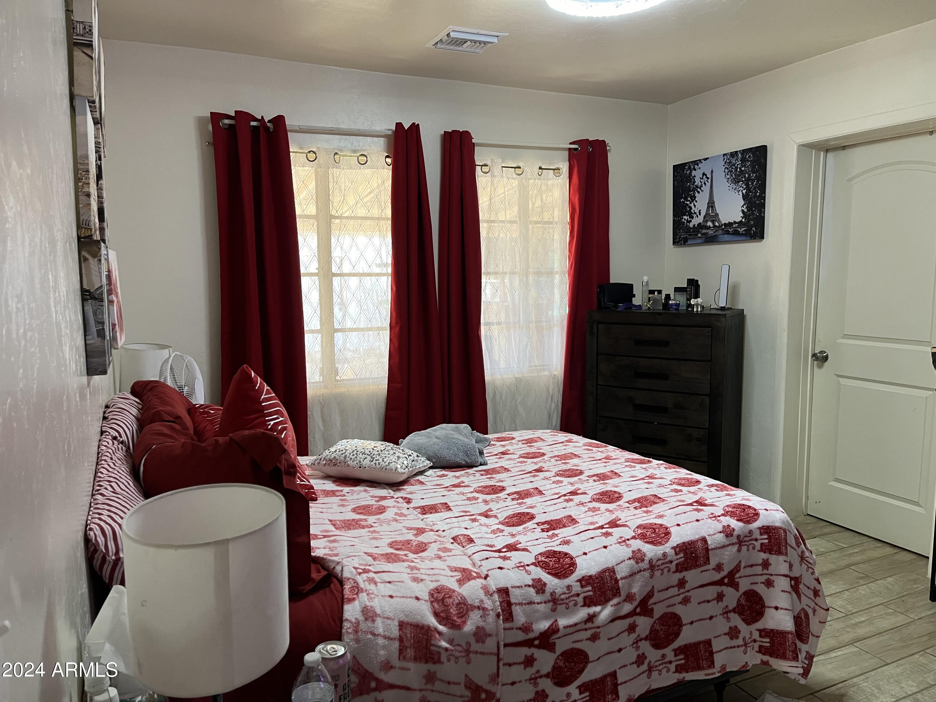 1517 East 9th Street Douglas, AZ 85607 - Photo 10 of 16 a bedroom with a bed and wooden floor