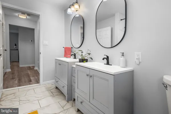 a bathroom with a tub sink and mirror