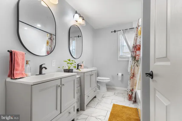 a bedroom with a bed and a mirror