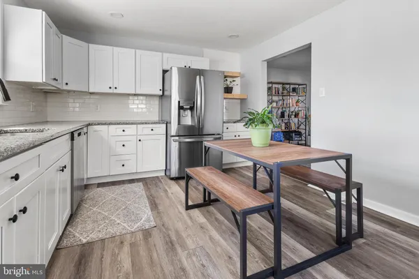 a kitchen with a refrigerator sink and cabinets