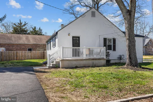 a view of a house with a yard and sitting area