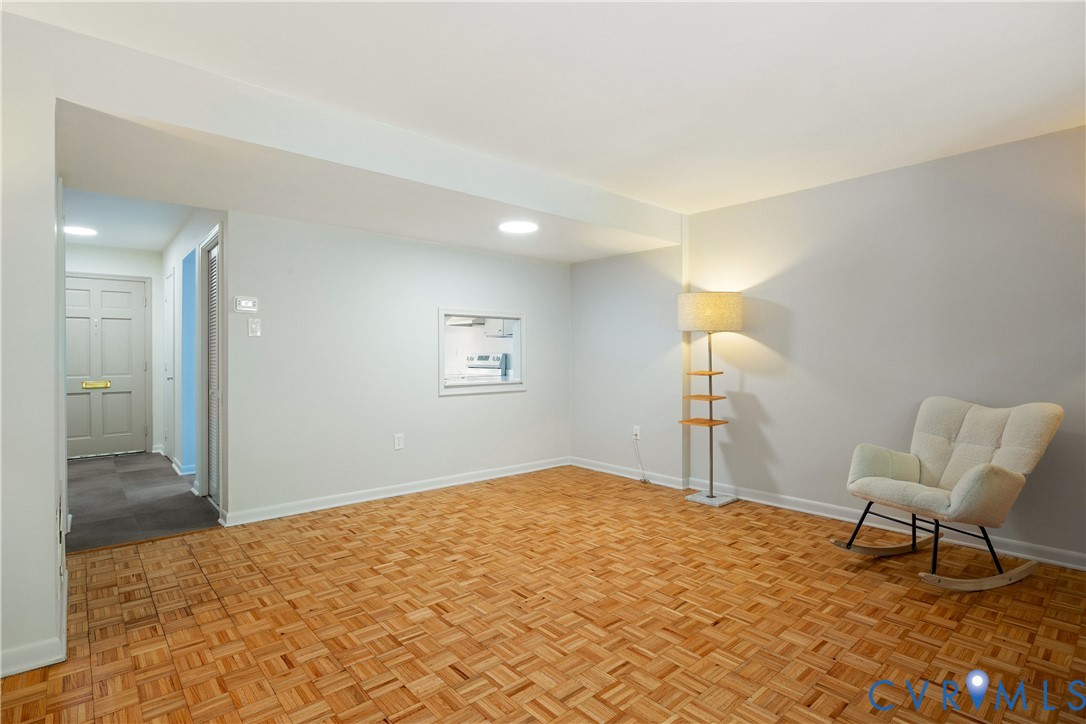 9129 Derbyshire Road, Unit E Henrico, VA 23229 - Photo 15 of 36 Living area with parquet wood flooring, white pain