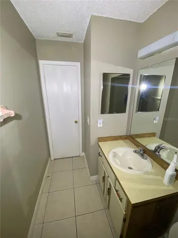 a bathroom with a sink and mirror