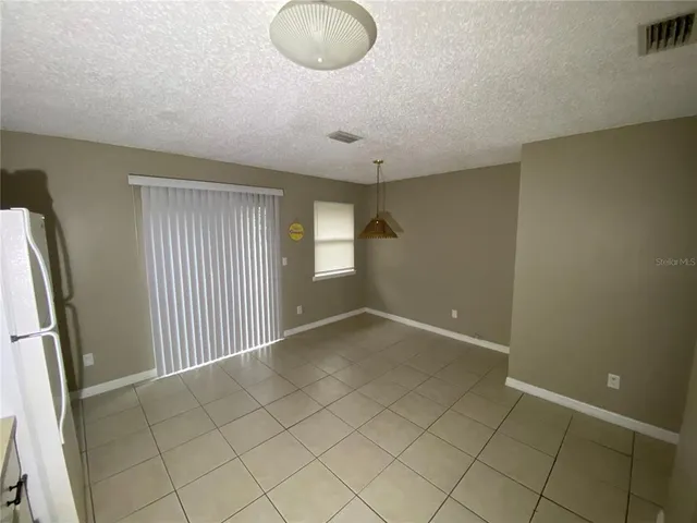 a view of a kitchen with refrigerator and microwave