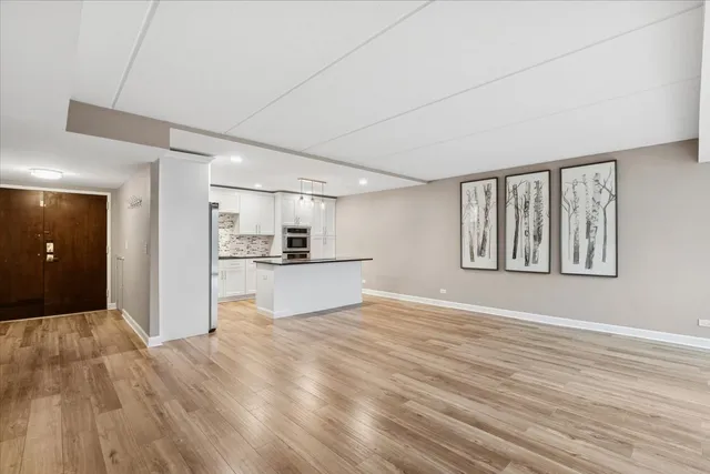 a view of a kitchen with microwave and refrigerator