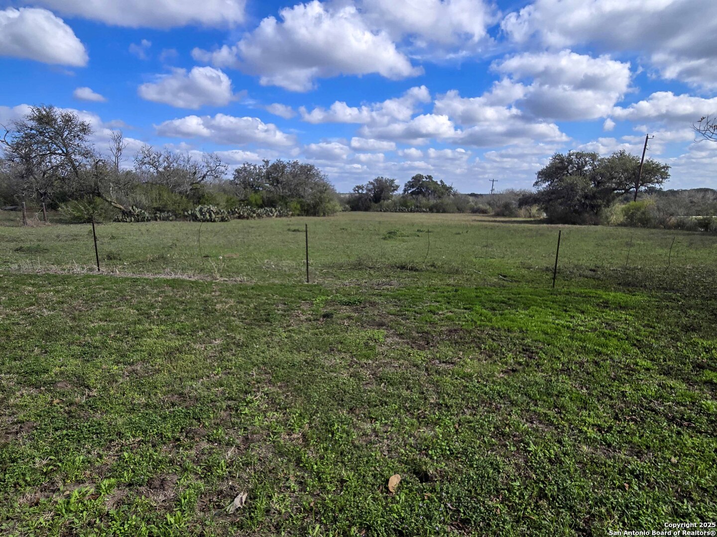 1173 Charco Road Beeville, TX 78102 - Photo 12 of 39 a view of a green field with wooden fence