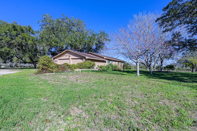 a view of a house with a backyard