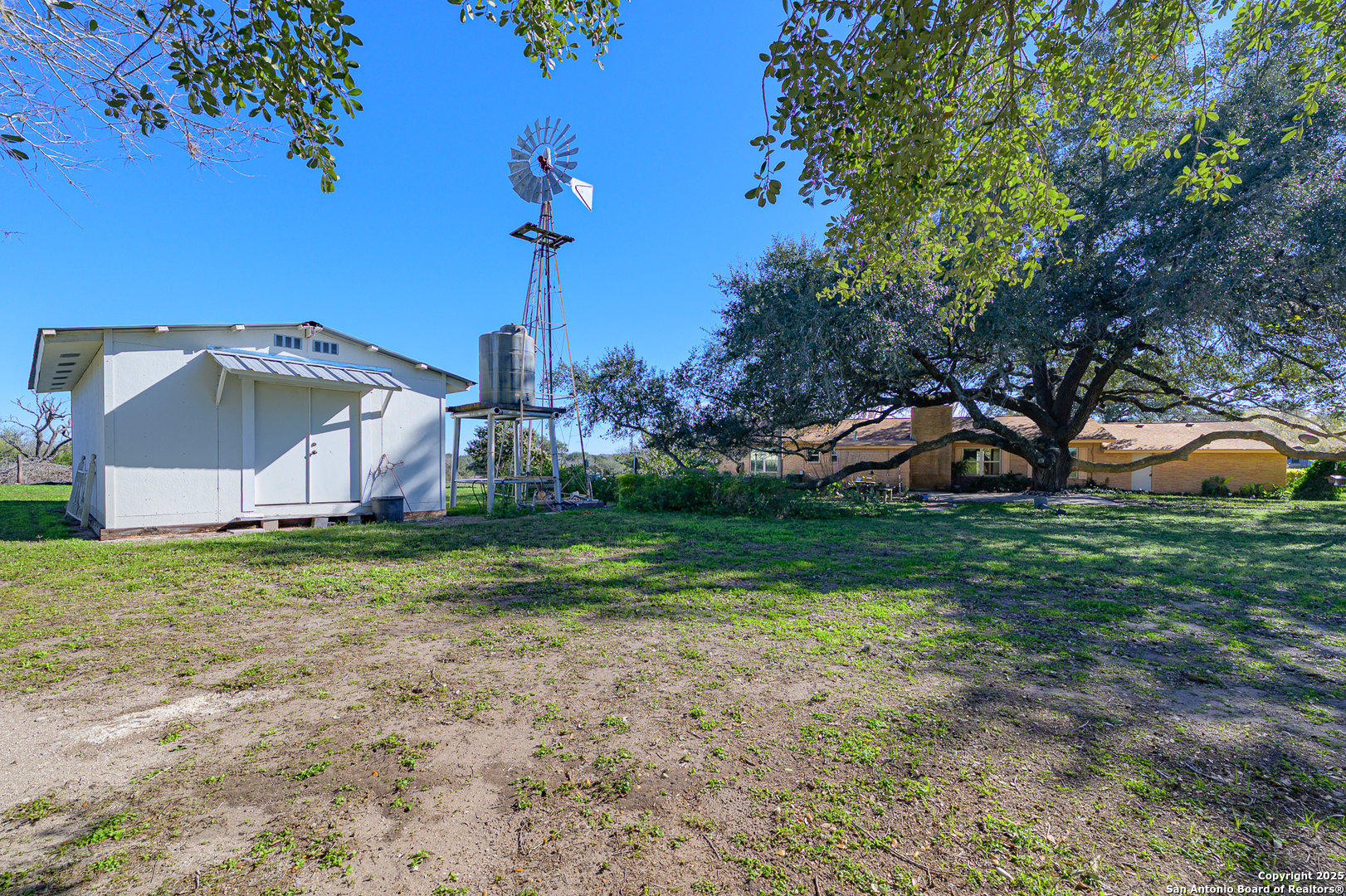 1173 Charco Road Beeville, TX 78102 - Photo 23 of 39 a view of a house with a backyard