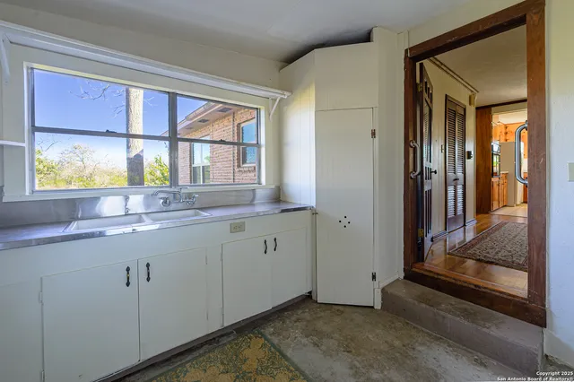 a kitchen with stainless steel appliances granite countertop a sink and cabinets