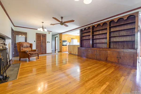 a view of empty room with wooden floor