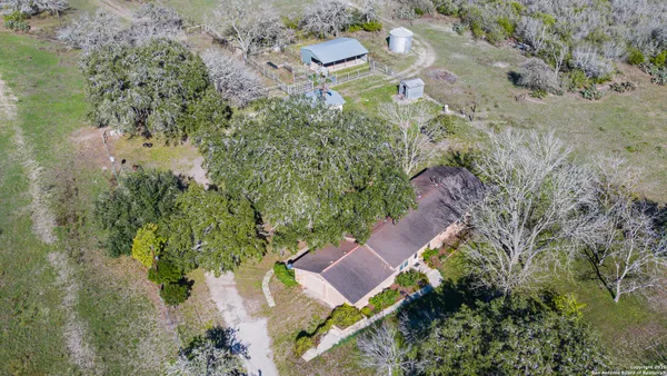an aerial view of a house with a yard