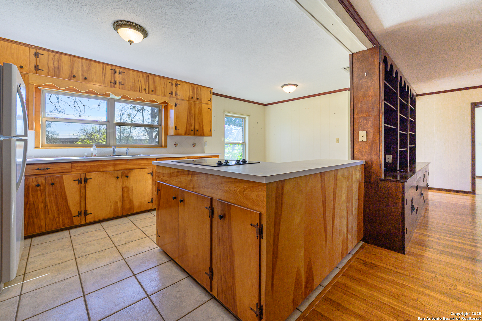 1173 Charco Road Beeville, TX 78102 - Photo 9 of 39 a kitchen with stainless steel appliances granite countertop a refrigerator and a stove top oven