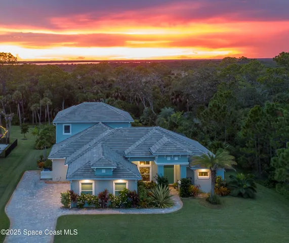 a view of a town with mountains front of house