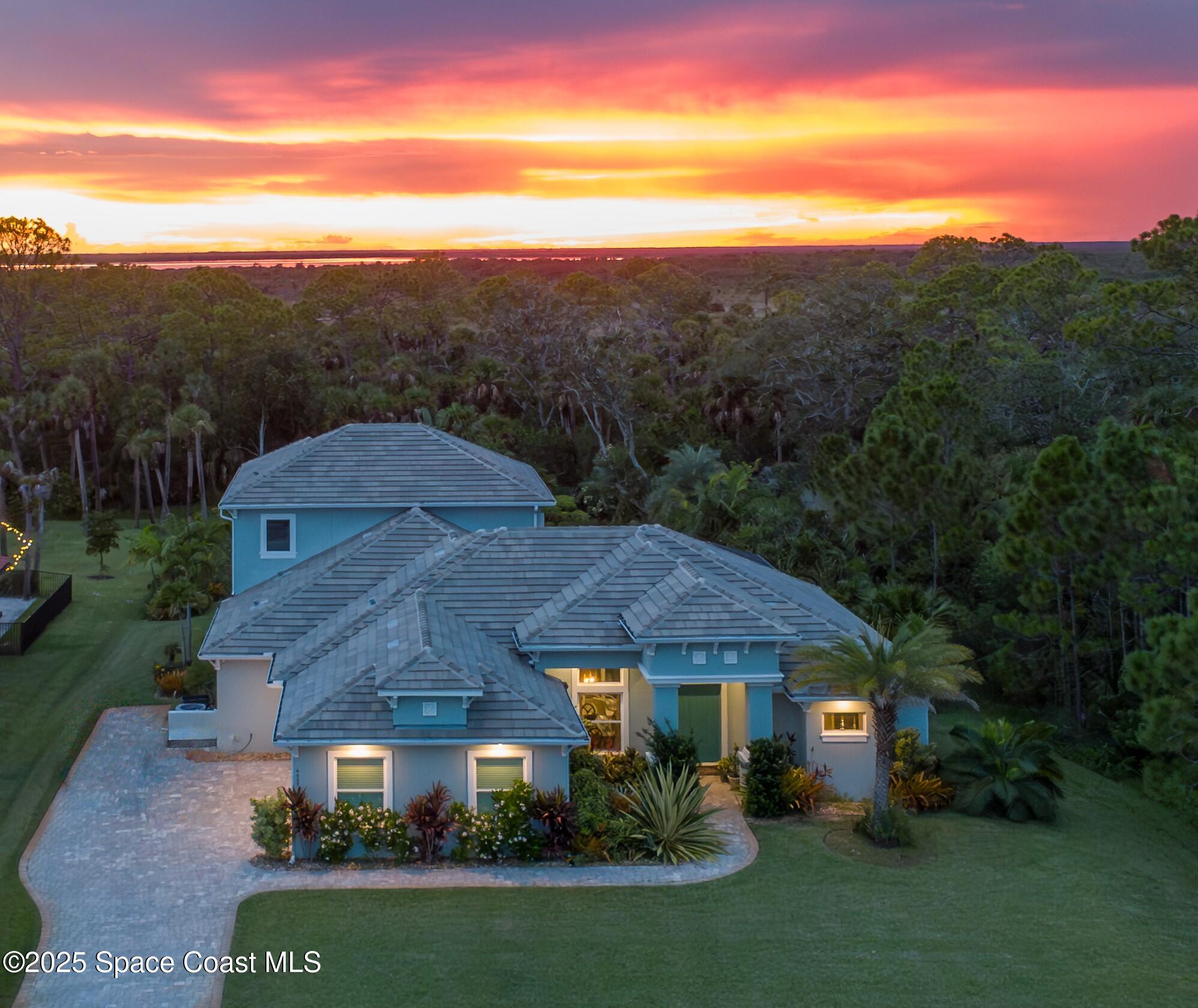 a view of a town with mountains front of house