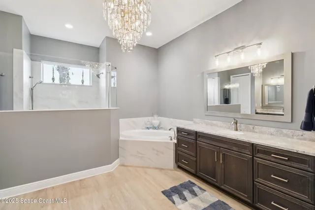 a spacious bathroom with a sink a large mirror and vanity
